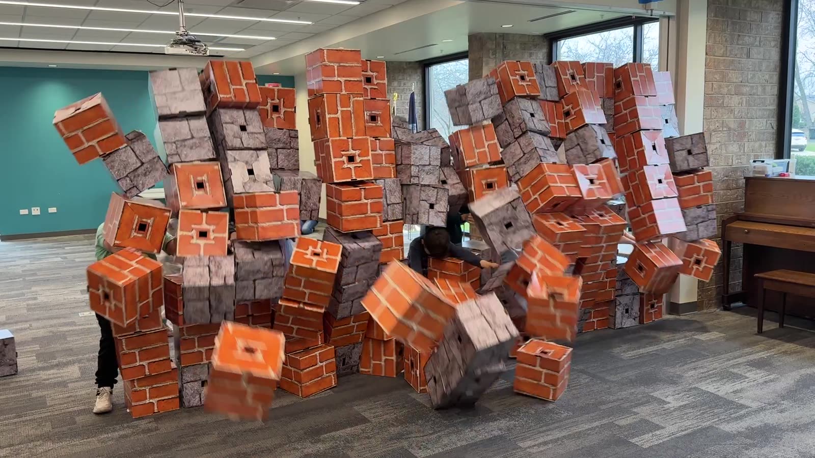 A child at a tall wall built from giant blocks