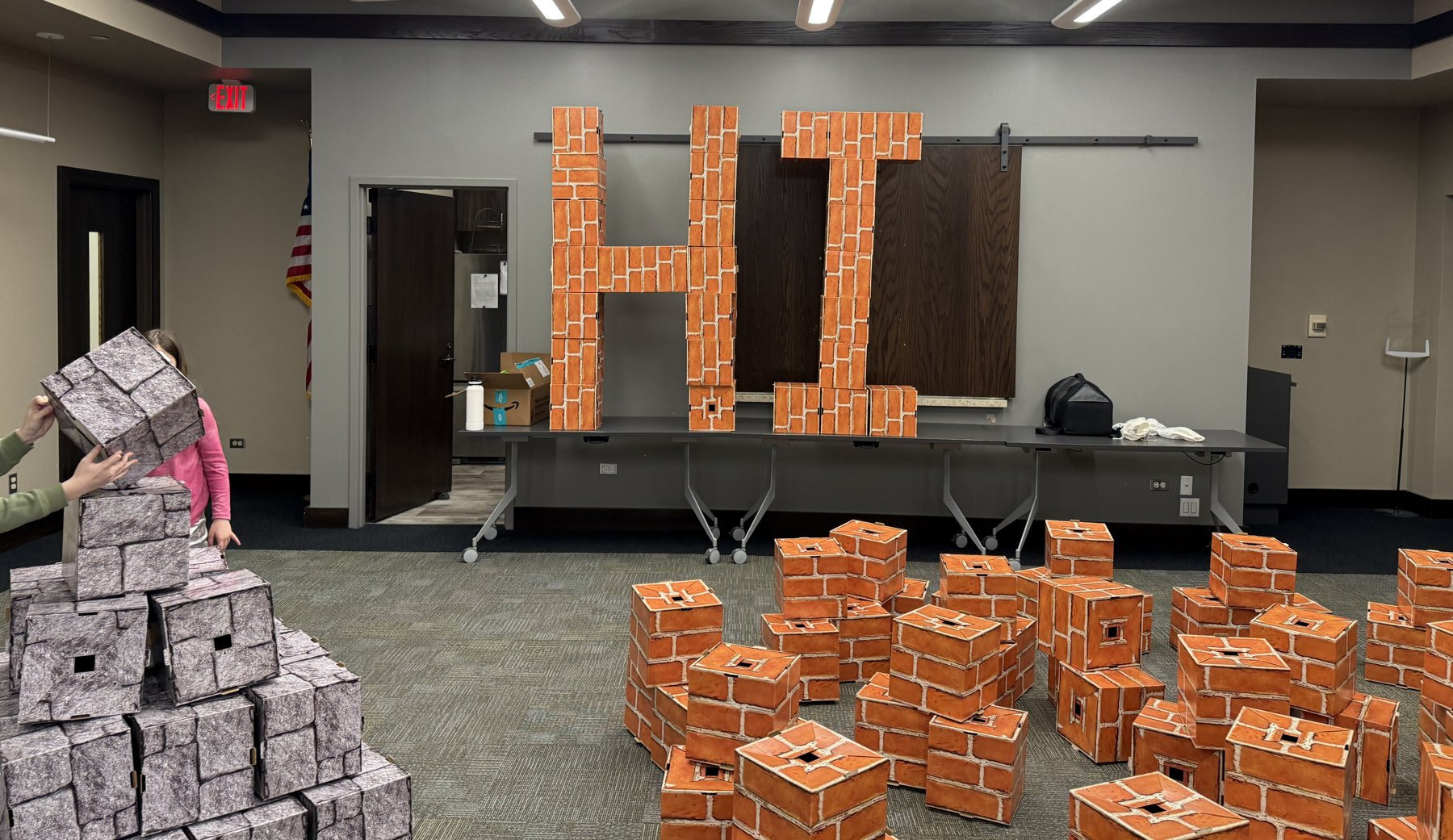 A giant HI built from blocks across a library room