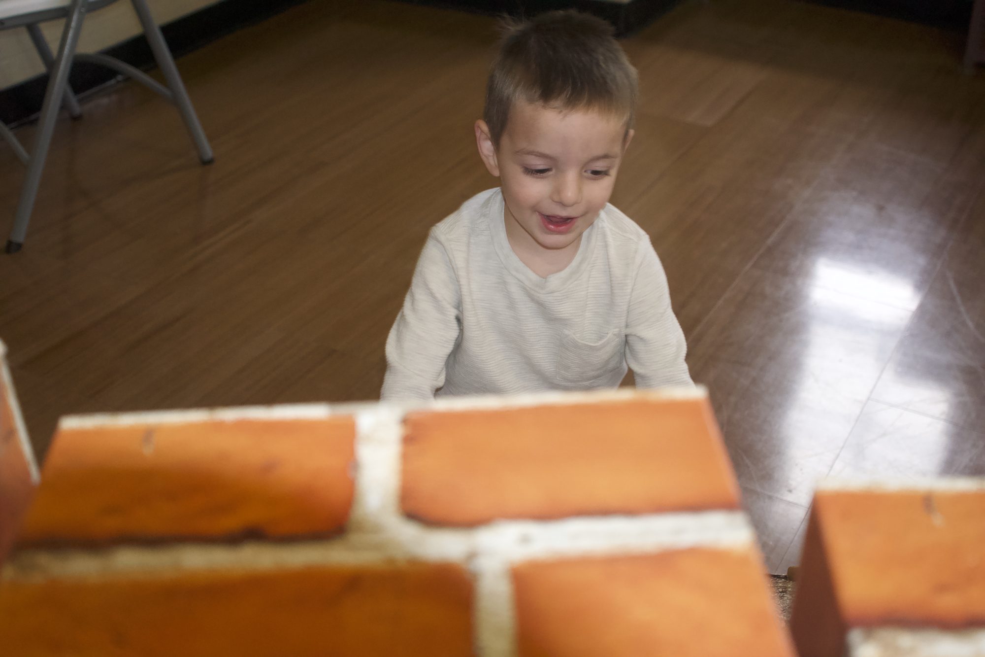 Children building inside a wall of giant blocks